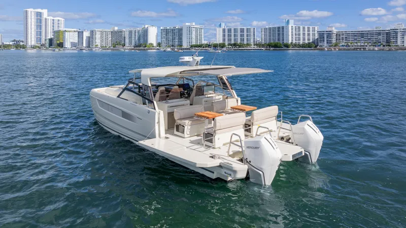 Yacht Photos Pics Luxury YOT 36 boat cruising on water, 2025 model, with city skyline in background.