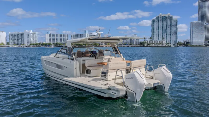  Yacht Photos Pics Luxurious 2025 YOT 36 yacht cruising near city skyline on a sunny day.