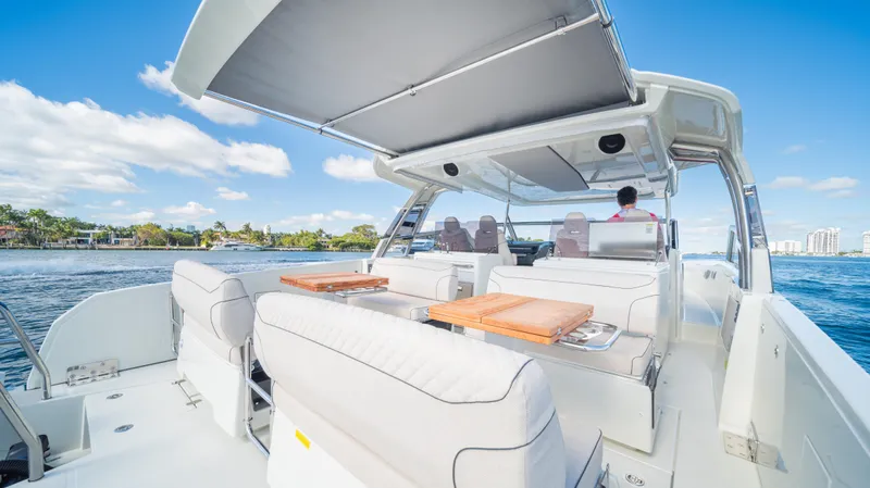  Yacht Photos Pics 2025 YOT 36 boat with spacious deck, luxury seating, and canopy on open water.