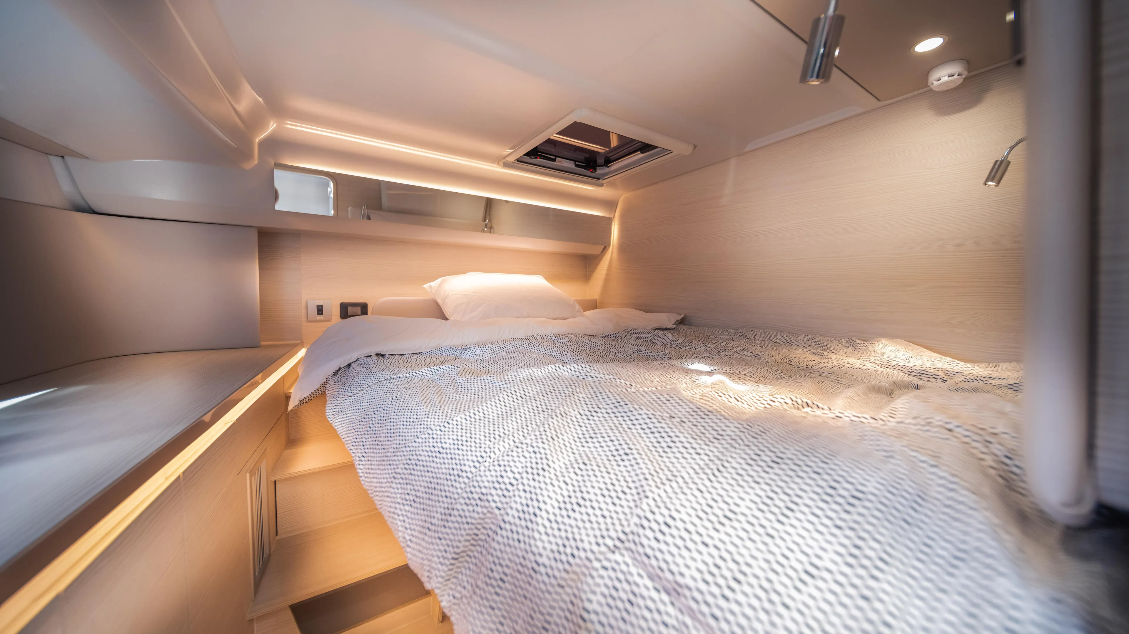  Yacht Photos Pics Luxurious cabin interior of 2025 YOT 36 yacht with cozy bedding and modern lighting.
