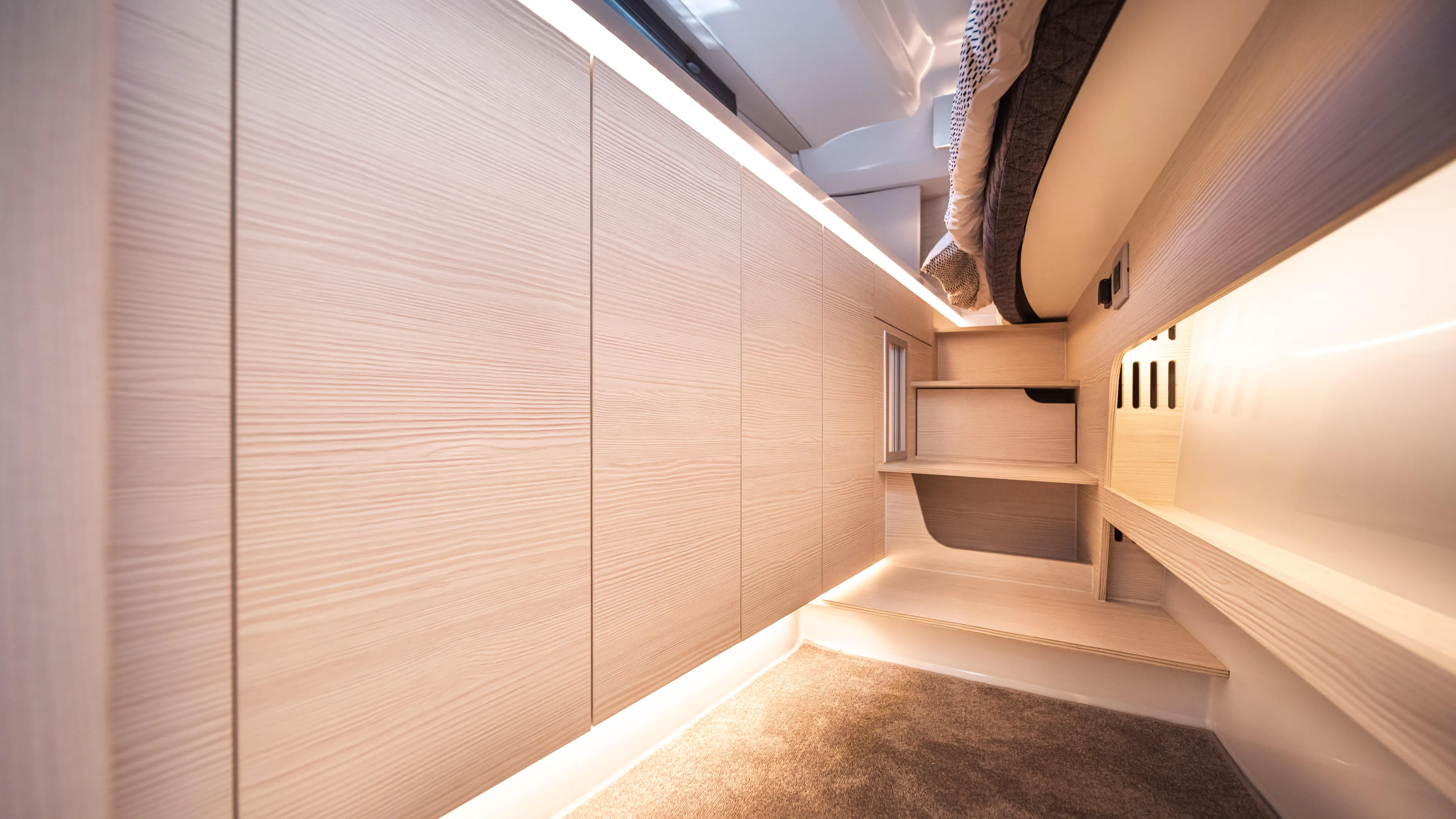 Yacht Photos Pics Modern interior of 2025 YOT 36 yacht with sleek wood paneling and ambient lighting.