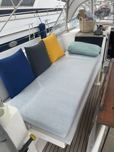 Southern Cross Yacht Photos Pics Cozy seating area on 2015 Dufour 560 Grand Large yacht with colorful cushions.