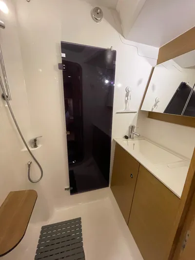 Southern Cross Yacht Photos Pics Bathroom interior of 2015 Dufour 560 Grand Large yacht, featuring modern fixtures and wooden accents.