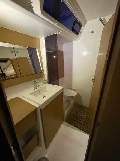 Southern Cross Yacht Photos Pics Bathroom interior of 2015 Dufour 560 Grand Large yacht, featuring modern fixtures and cabinetry.