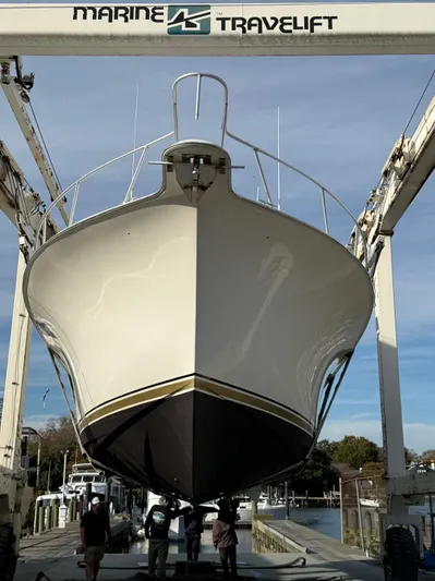 Series 60, Repainted Yacht Photos Pics Ocean Yachts 48 Convertible 2000 in harbor with Travelift.