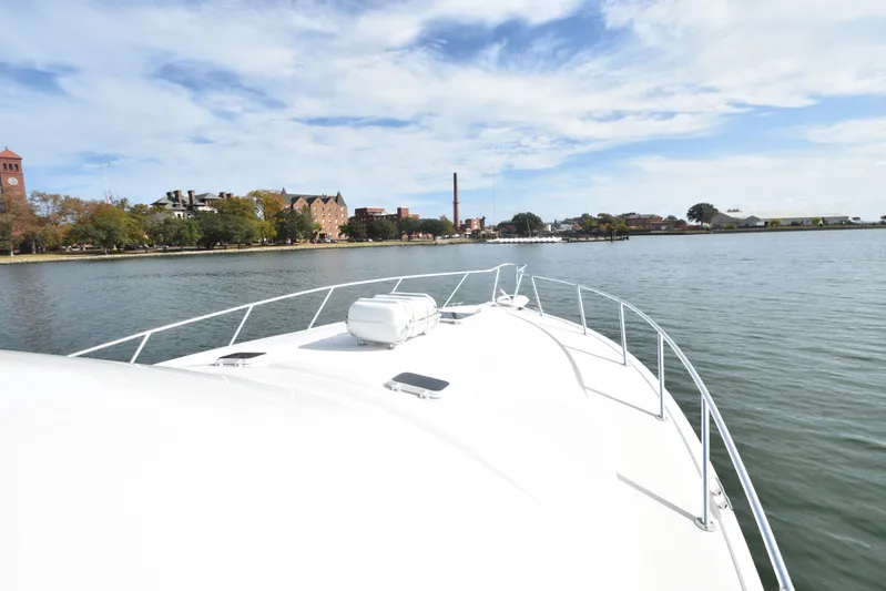 Series 60, Repainted Yacht Photos Pics Ocean Yachts 48 Convertible 2000 on calm water with city view.