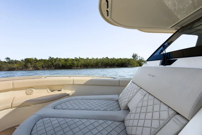 Our Trade Yacht Photos Pics 2019 Chris-Craft Catalina 30 interior with luxurious seating, overlooking serene water and greenery.