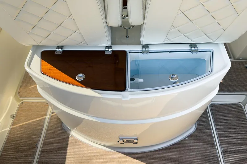Our Trade Yacht Photos Pics 2019 Chris-Craft Catalina 30 boat interior with storage compartments and cushioned seating.
