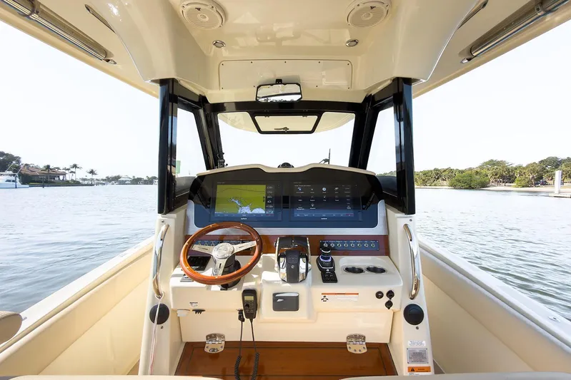 Our Trade Yacht Photos Pics 2019 Chris-Craft Catalina 30 helm with modern navigation system and wooden steering wheel.