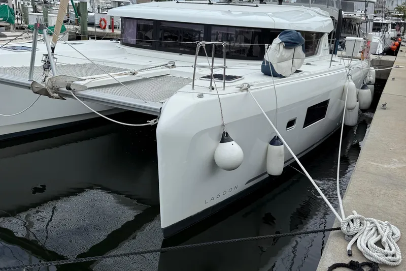 Jelliblu Yacht Photos Pics 2019 Lagoon 42 catamaran docked at marina, featuring sleek design and modern amenities.