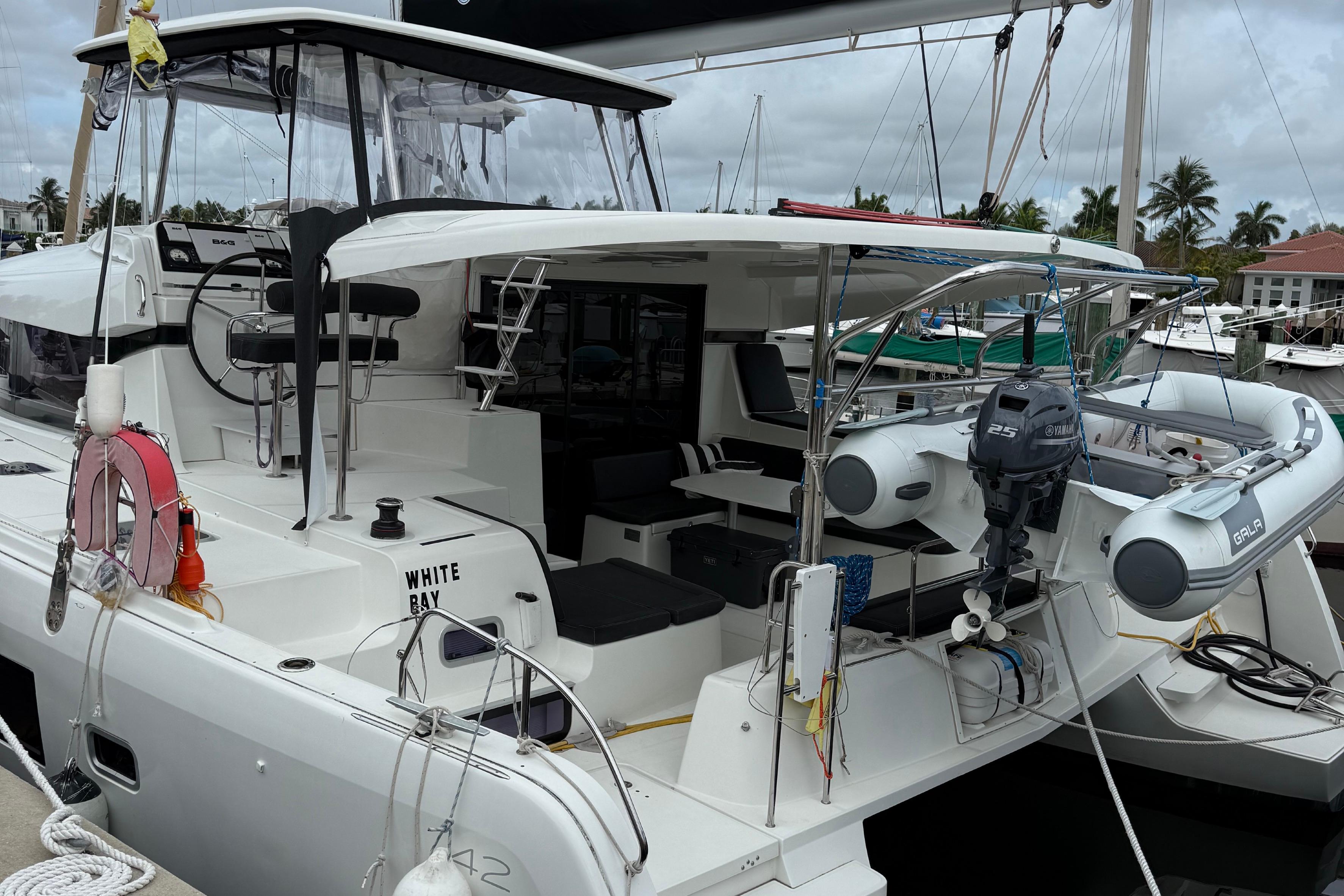 2019 Lagoon 42 catamaran docked, featuring spacious deck and modern amenities.