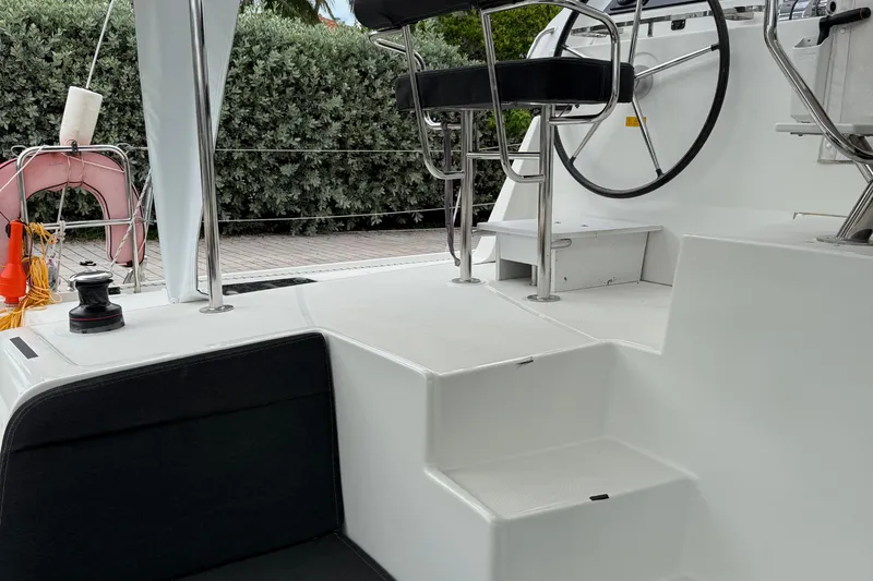 Jelliblu Yacht Photos Pics Cockpit of 2019 Lagoon 42 catamaran with steering wheel and seating area.