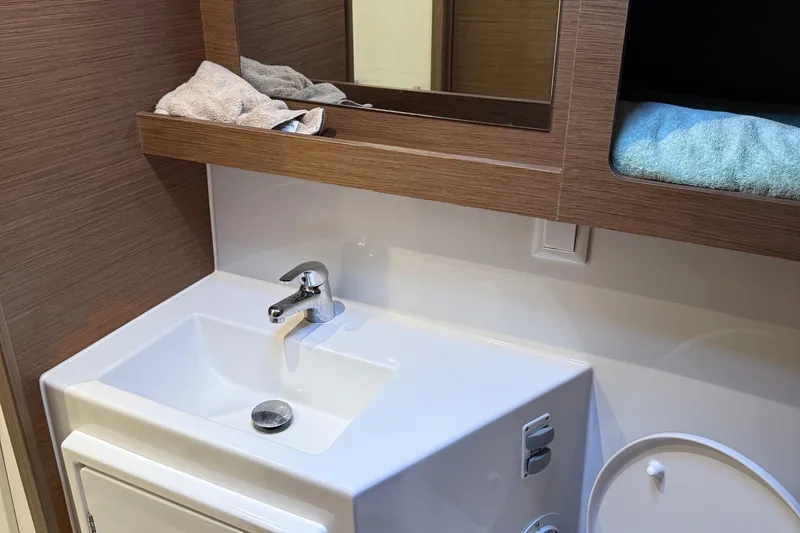 Jelliblu Yacht Photos Pics Modern bathroom sink in 2019 Lagoon 42 yacht with wooden accents and mirror.