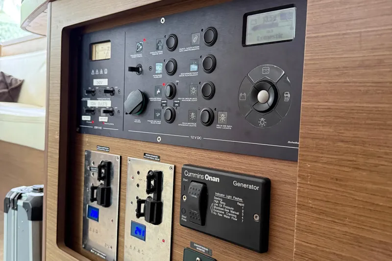 Jelliblu Yacht Photos Pics Control panel of a 2019 Lagoon 42 yacht, featuring various switches and a Cummins Onan generator.