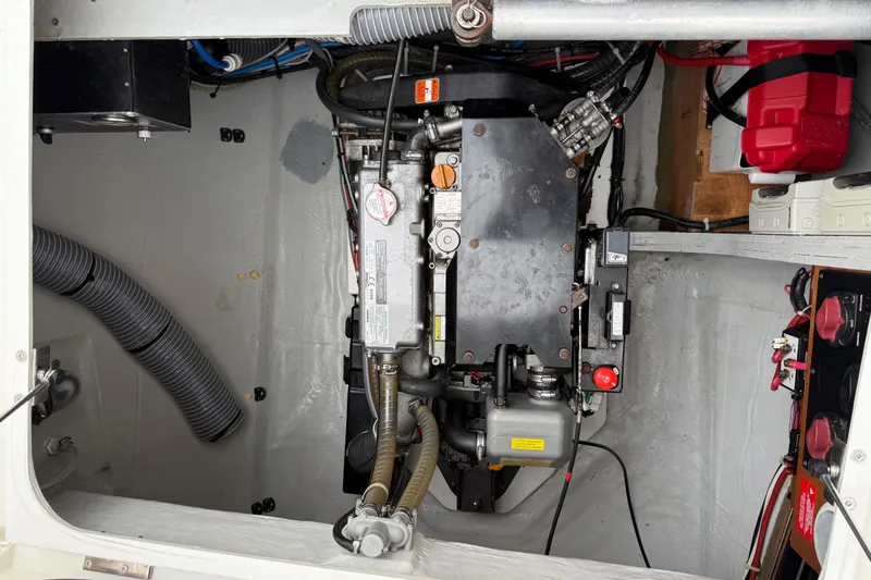 Jelliblu Yacht Photos Pics Engine compartment of a 2019 Lagoon 42 catamaran, showcasing mechanical components and wiring.