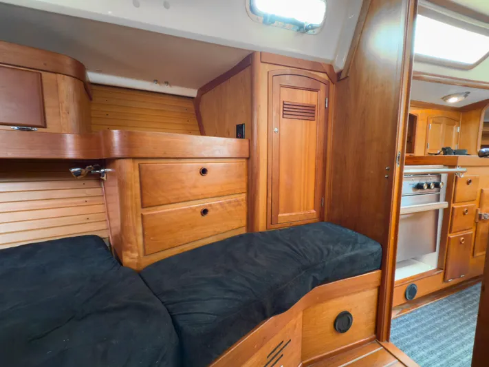 Ulrica Yacht Photos Pics Interior of a 1997 Sabre 402 sailboat with wooden cabinetry and cozy sleeping area.