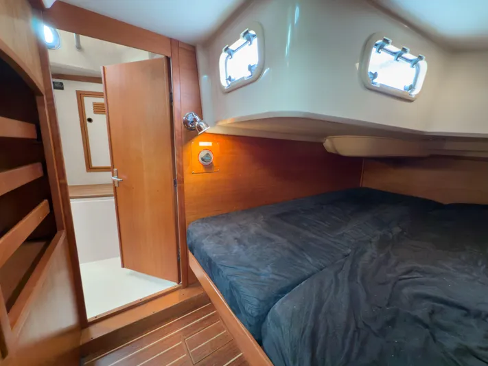 Ulrica Yacht Photos Pics Cozy cabin interior of 1997 Sabre 402 sailboat with wooden finish and comfortable bedding.