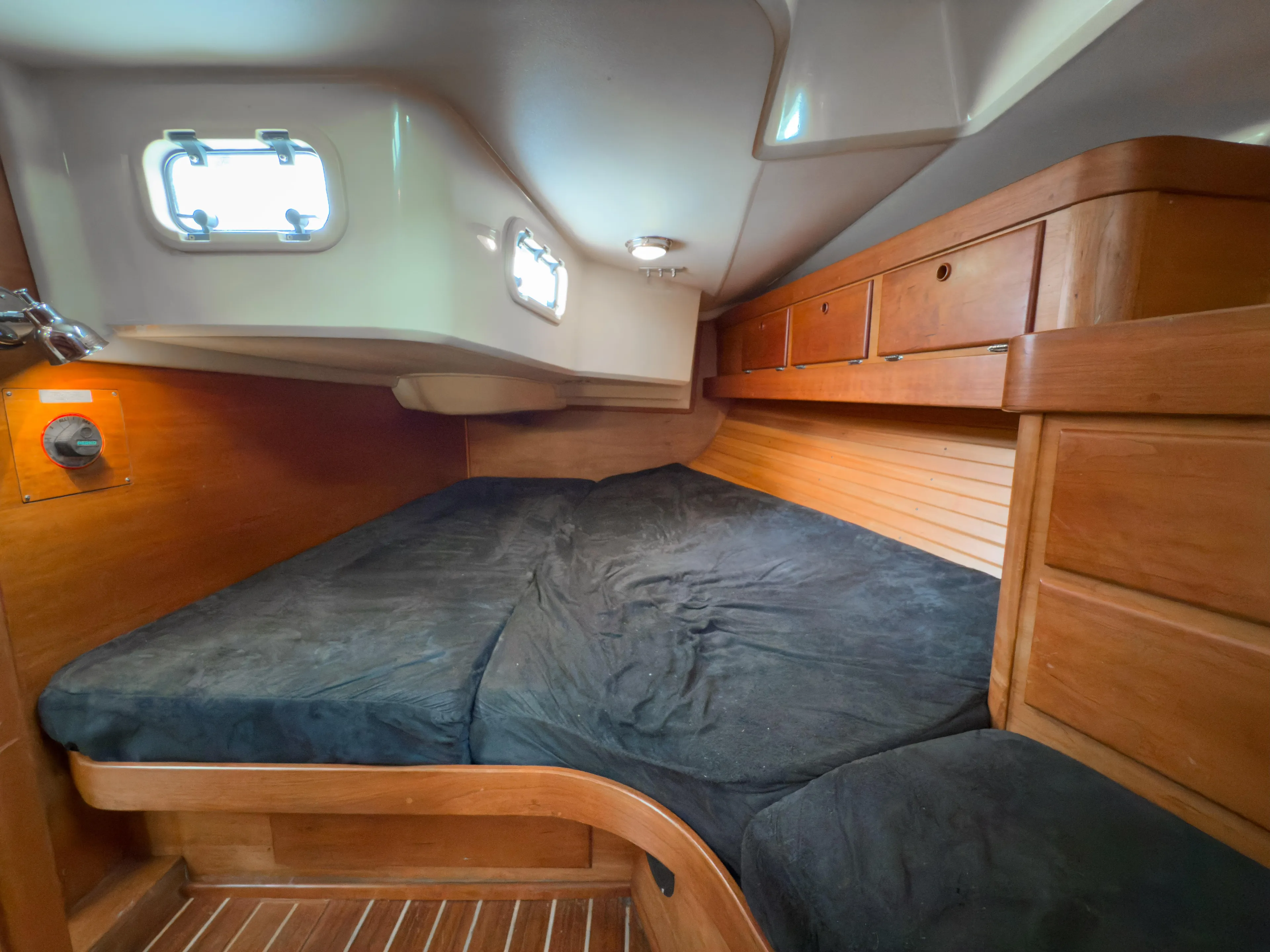 Ulrica Yacht Photos Pics Cozy cabin interior of 1997 Sabre 402 sailboat with wooden finish and portholes.