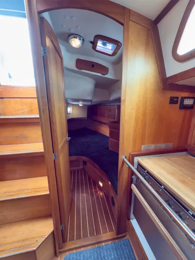Ulrica Yacht Photos Pics Interior of a 1997 Sabre 402 sailboat, featuring wooden cabinetry and cozy sleeping quarters.