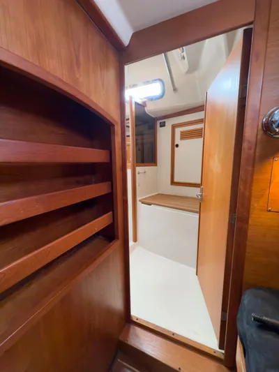Ulrica Yacht Photos Pics Interior view of 1997 Sabre 402 sailboat with wooden cabinetry and open door.