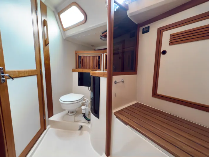Ulrica Yacht Photos Pics Interior of 1997 Sabre 402 yacht bathroom with wooden accents and modern fixtures.