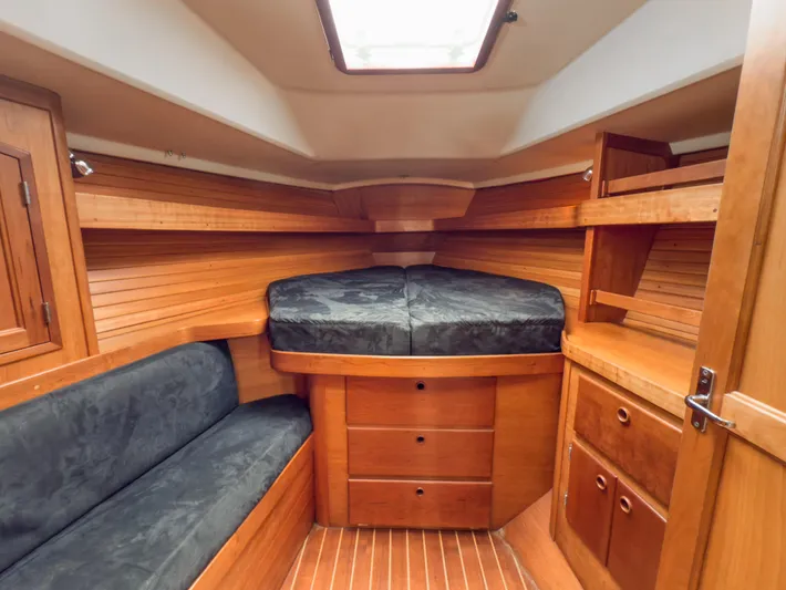Ulrica Yacht Photos Pics Interior of 1997 Sabre 402 sailboat with wooden cabinetry and cozy sleeping area.