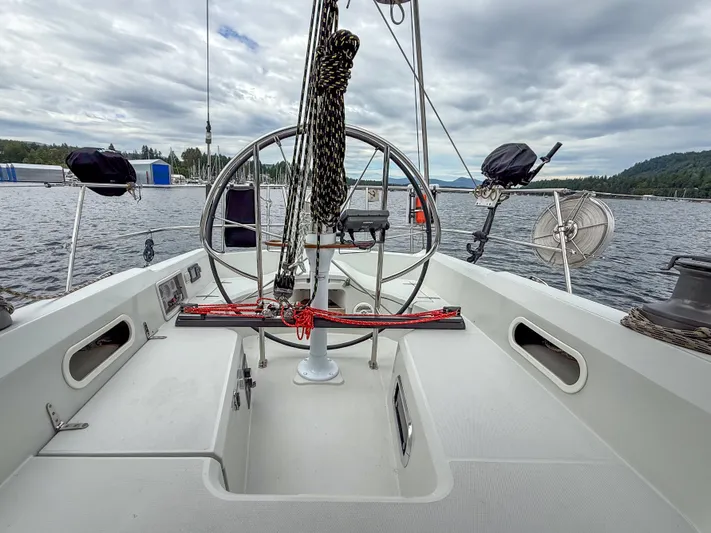 Ulrica Yacht Photos Pics Sailboat cockpit view, Sabre 402, 1997 model, on a calm lake under cloudy skies.