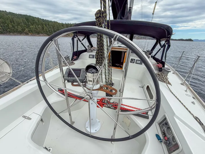Ulrica Yacht Photos Pics Sailboat cockpit view of 1997 Sabre 402, featuring steering wheel and scenic water backdrop.