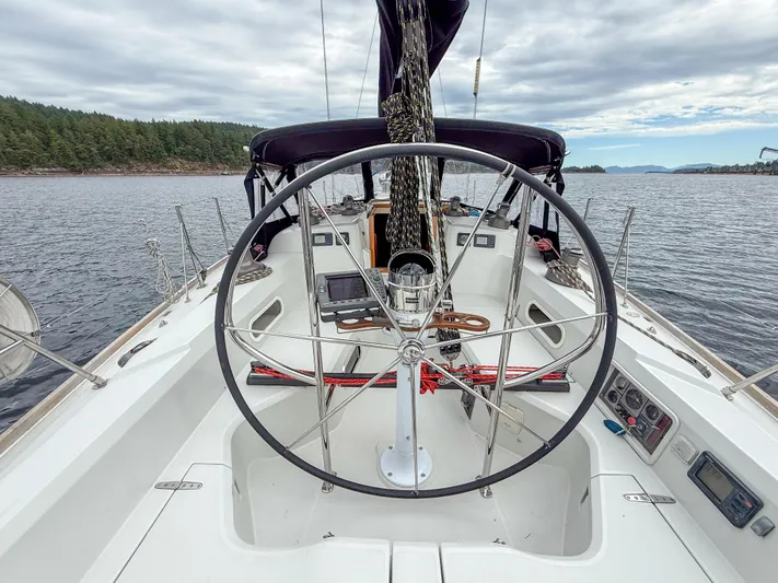 Ulrica Yacht Photos Pics Sailboat cockpit view, Sabre 402, 1997 model, steering wheel, open water, cloudy sky.