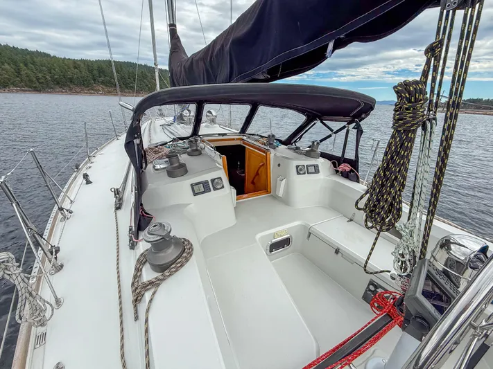 Ulrica Yacht Photos Pics Sailboat Sabre 402, 1997 model, with open cockpit and ropes, anchored near forested shoreline.