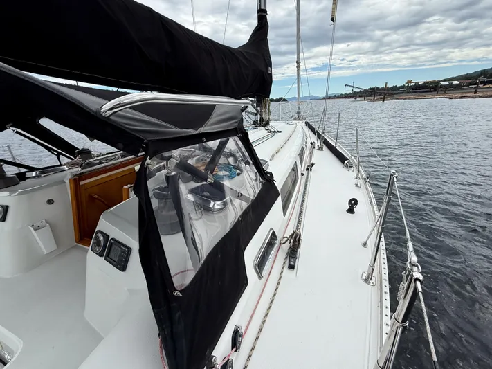 Ulrica Yacht Photos Pics 1997 Sabre 402 sailboat on calm water, featuring sleek deck and black sail cover.
