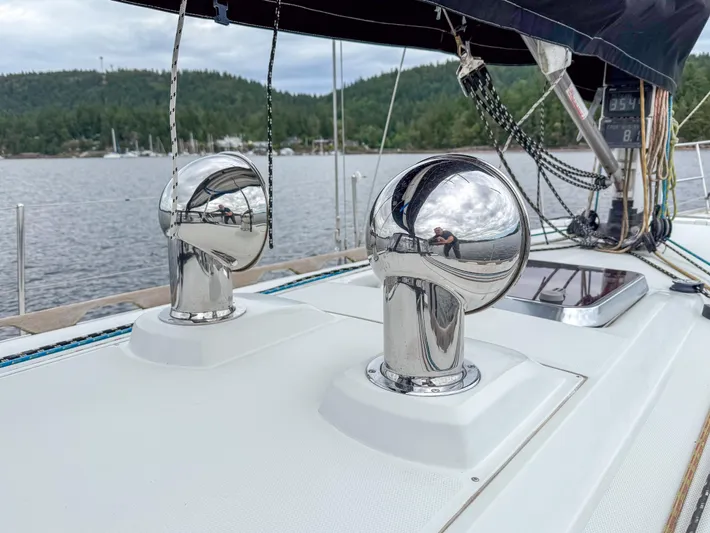 Ulrica Yacht Photos Pics 1997 Sabre 402 sailboat deck with chrome vents, scenic lake background.