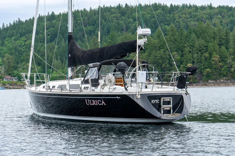 Ulrica Yacht Photos Pics Sailing yacht Sabre 402, 1997 model, on calm water with forested background.
