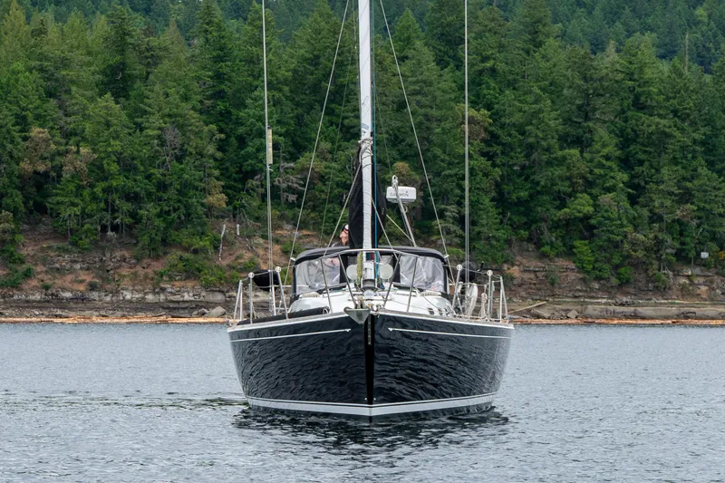 Ulrica Yacht Photos Pics Sailing yacht Sabre 402, 1997 model, cruising on a serene lake with forested backdrop.