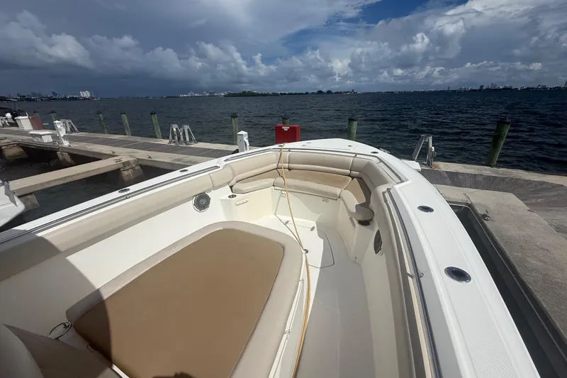 Dulce Vita Yacht Photos Pics 2016 Boston Whaler 330 Outrage docked, showcasing spacious seating and ocean view.