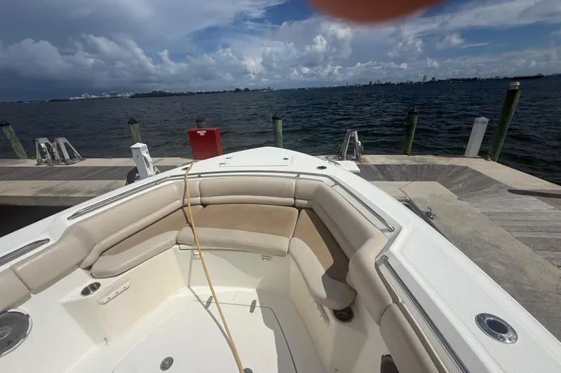 Dulce Vita Yacht Photos Pics 2016 Boston Whaler 330 Outrage boat docked by the waterfront under cloudy skies.