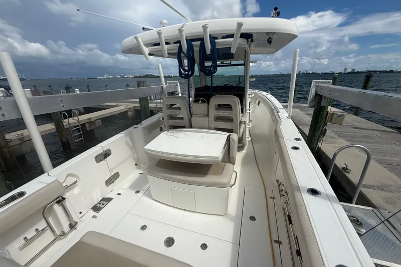 Dulce Vita Yacht Photos Pics 2016 Boston Whaler 330 Outrage boat docked, showcasing spacious deck and seating area.