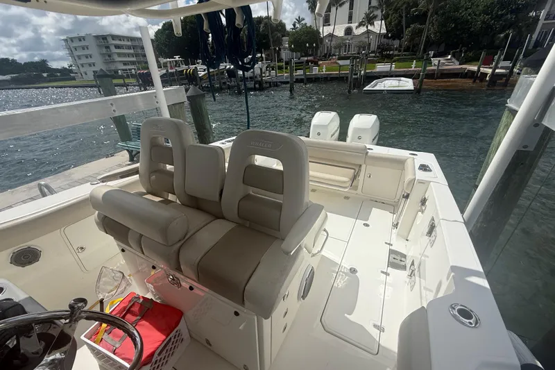 Dulce Vita Yacht Photos Pics 2016 Boston Whaler 330 Outrage boat interior at dock, featuring seating and dual engines.
