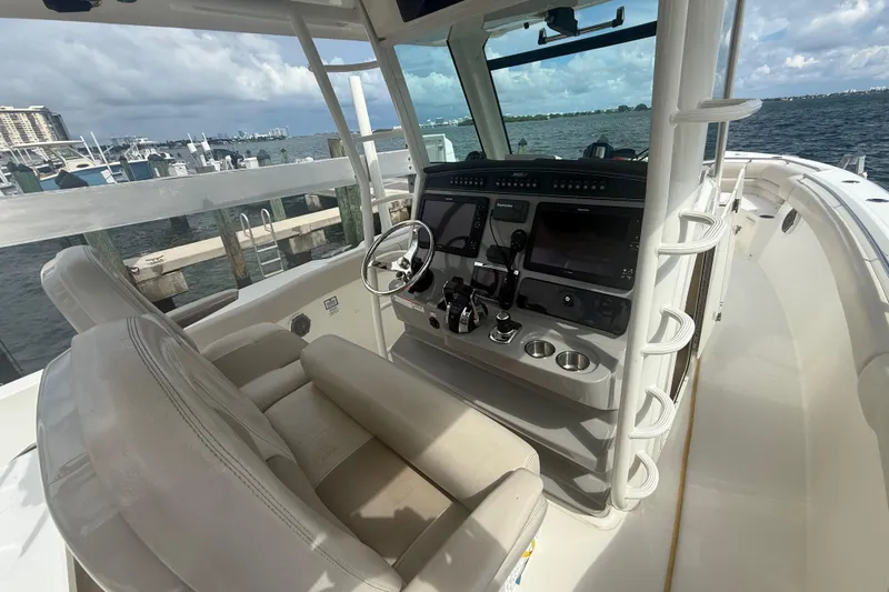 Dulce Vita Yacht Photos Pics 2016 Boston Whaler 330 Outrage helm with dual screens, docked by the marina.