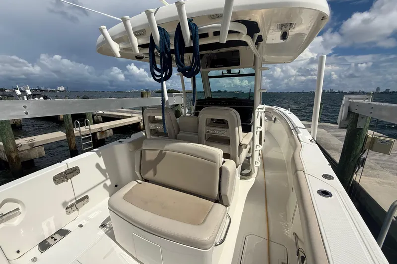 Dulce Vita Yacht Photos Pics 2016 Boston Whaler 330 Outrage boat interior at dock, featuring seating and helm.