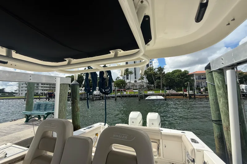 Dulce Vita Yacht Photos Pics 2016 Boston Whaler 330 Outrage docked, showcasing interior seating and waterfront view.