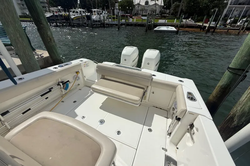 Dulce Vita Yacht Photos Pics 2016 Boston Whaler 330 Outrage boat docked, featuring spacious seating and dual engines.