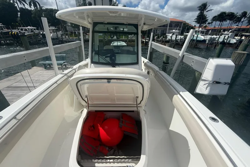 Dulce Vita Yacht Photos Pics 2016 Boston Whaler 330 Outrage boat with open storage compartment at marina.