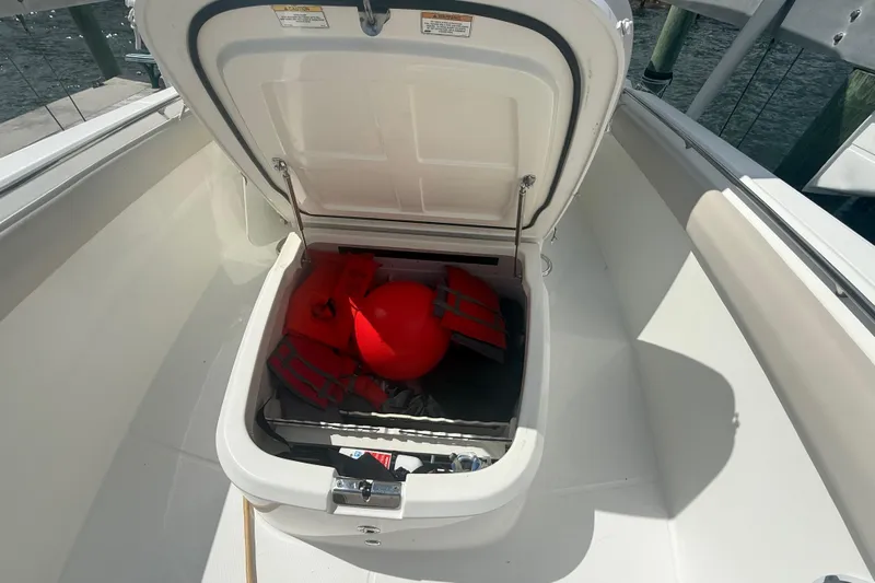 Dulce Vita Yacht Photos Pics Open storage compartment on 2016 Boston Whaler 330 Outrage with life jackets and buoy.