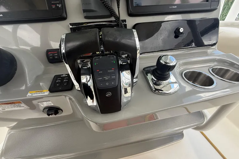 Dulce Vita Yacht Photos Pics Control panel of a 2016 Boston Whaler 330 Outrage boat with throttle and joystick.