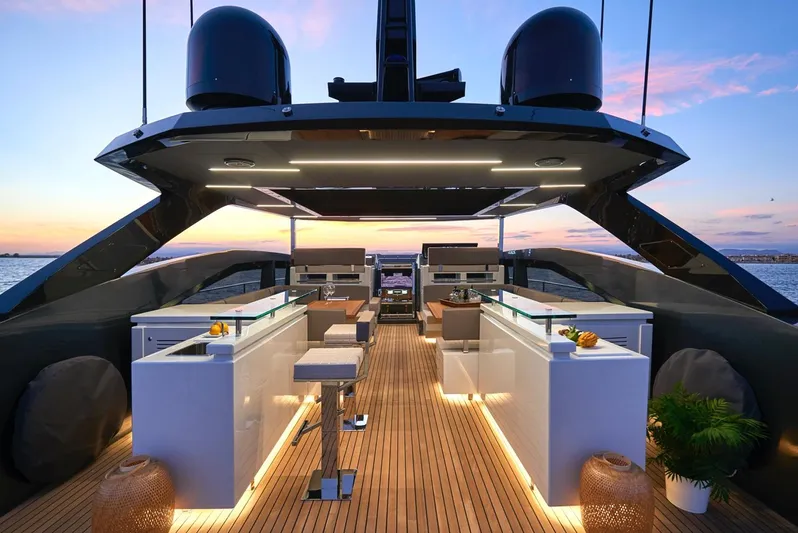 Armaar Yacht Photos Pics Luxurious 2017 Astondoa AS100 Century yacht deck at sunset, featuring modern design and elegant lighting.