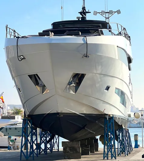 Armaar Yacht Photos Pics 2017 Astondoa AS100 Century yacht on dry dock, front view, supported by blue stands.