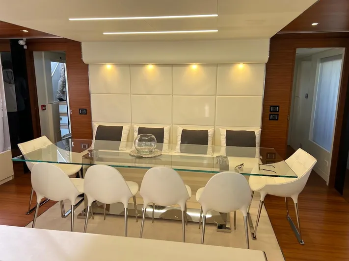 Armaar Yacht Photos Pics Luxurious dining area on 2017 Astondoa AS100 Century yacht with modern glass table and white chairs.