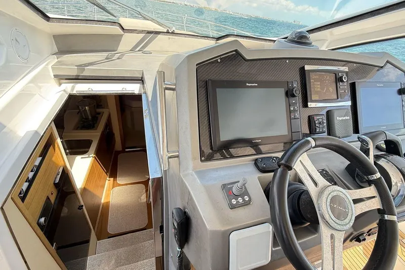 2017 Azimut Verve 40 @ Cancun Yacht Photos Pics 2017 Azimut Verve 40 yacht cockpit with modern navigation equipment and cabin entrance.