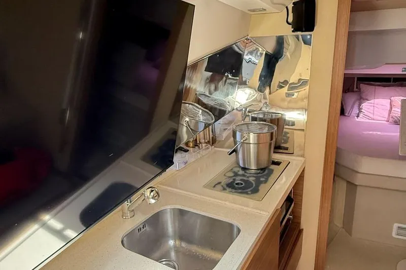 2017 Azimut Verve 40 @ Cancun Yacht Photos Pics Interior of 2017 Azimut Verve 40 yacht with kitchenette and cozy sleeping area.